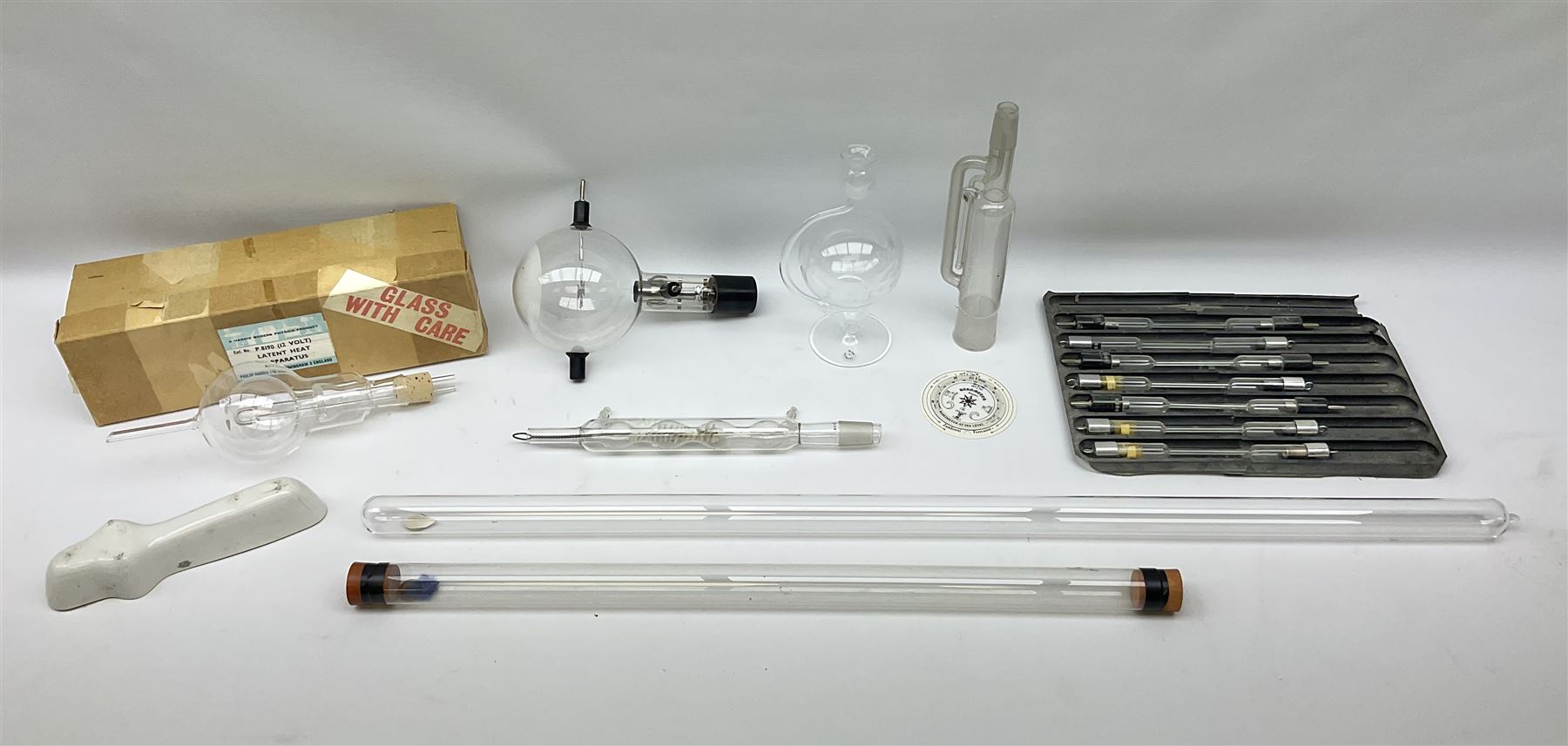 Quantity of laboratory and physics glassware including 'Guinea and Feather' equipment; boxed Latent Heat apparatus; Maltese Cross tube; atmospheric air pressure indicator flask; electroscope discharge tubes etc