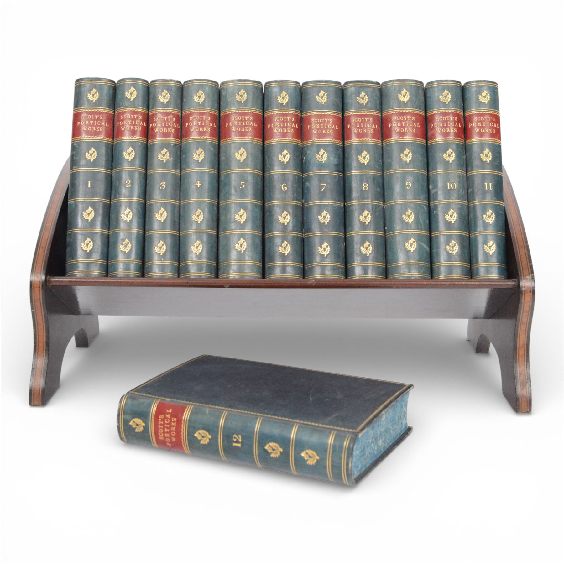 Edwardian book trough, the serpentine ends with boxwood stringing, pierced foliate keyhole shaped detail, and integrated shaped supports, housing Scott, Sir Walter, Poetical Works, Edinburgh, 1868, 12 vols, book trough 18.5cm x 38cm x 22.5cm
