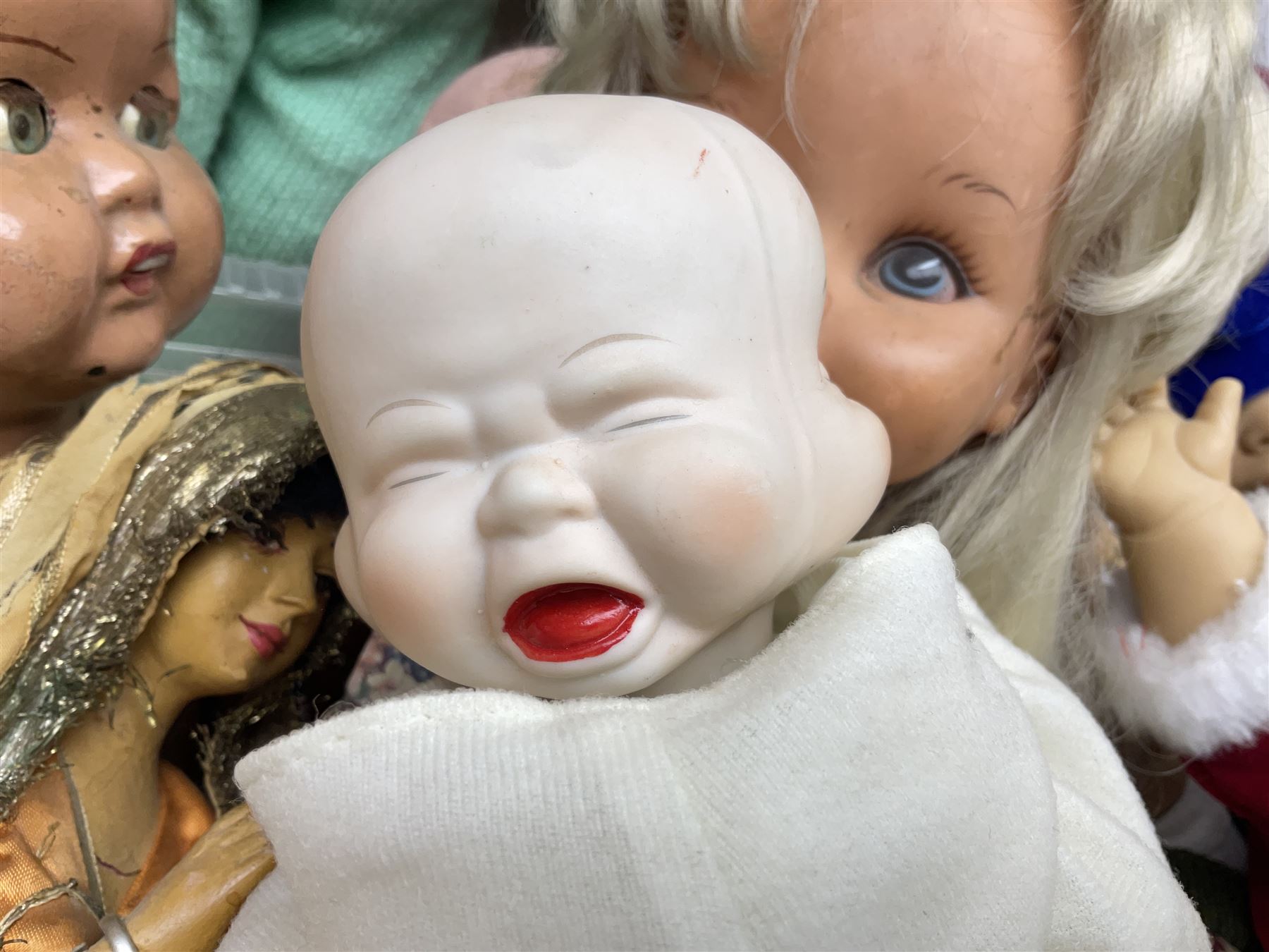 Quantity of vintage and later dolls to include unusual three faced example and further dolls marked C.J, Gloobee, Rosebud etc in three boxes