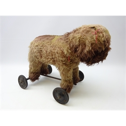  Early 20th century straw filled push dog on wheels, L54cm   