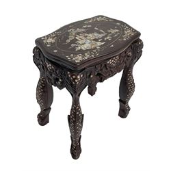 Early 20th century Chinese hardwood stand or side table, the shaped top with mother of pearl inlays depicting traditional landscape scene with figures, carved and pierced friezes with dragon masks, on scaled supports