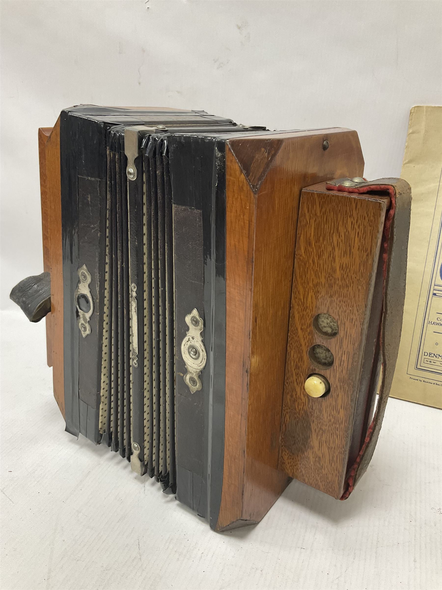 Three European concertinas, comprising Viceroy German concertina with 21 keys, hexagon wooden frame and 8 fold bellows
Oak framed concertina with 12 keys and 8 fold bellows
Commander concertina with 12 keys and 12 fold bellows
With tutor