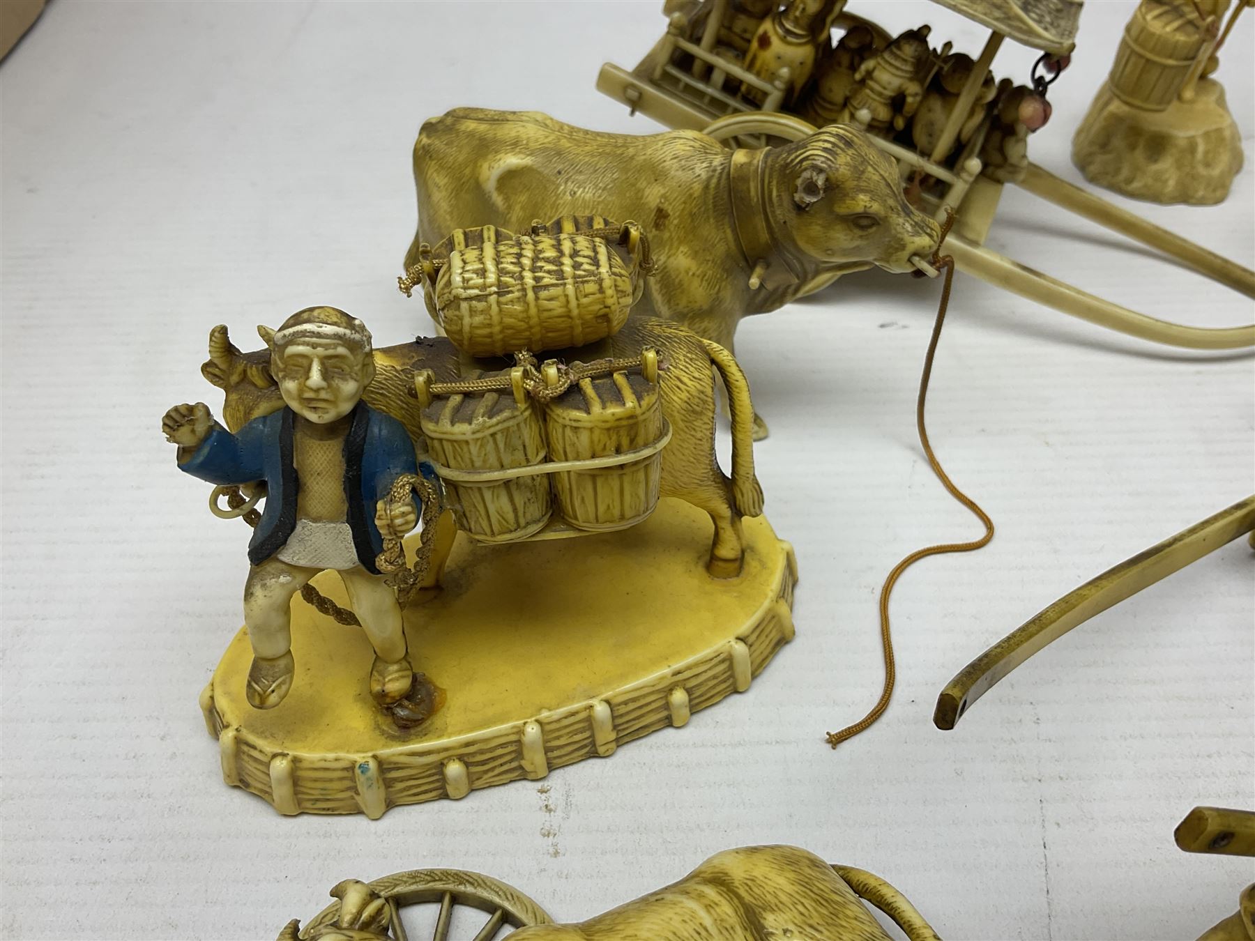 Collection of Japanese celluloid figures, including Rickshaw groups, fishing scene, oxen etc 