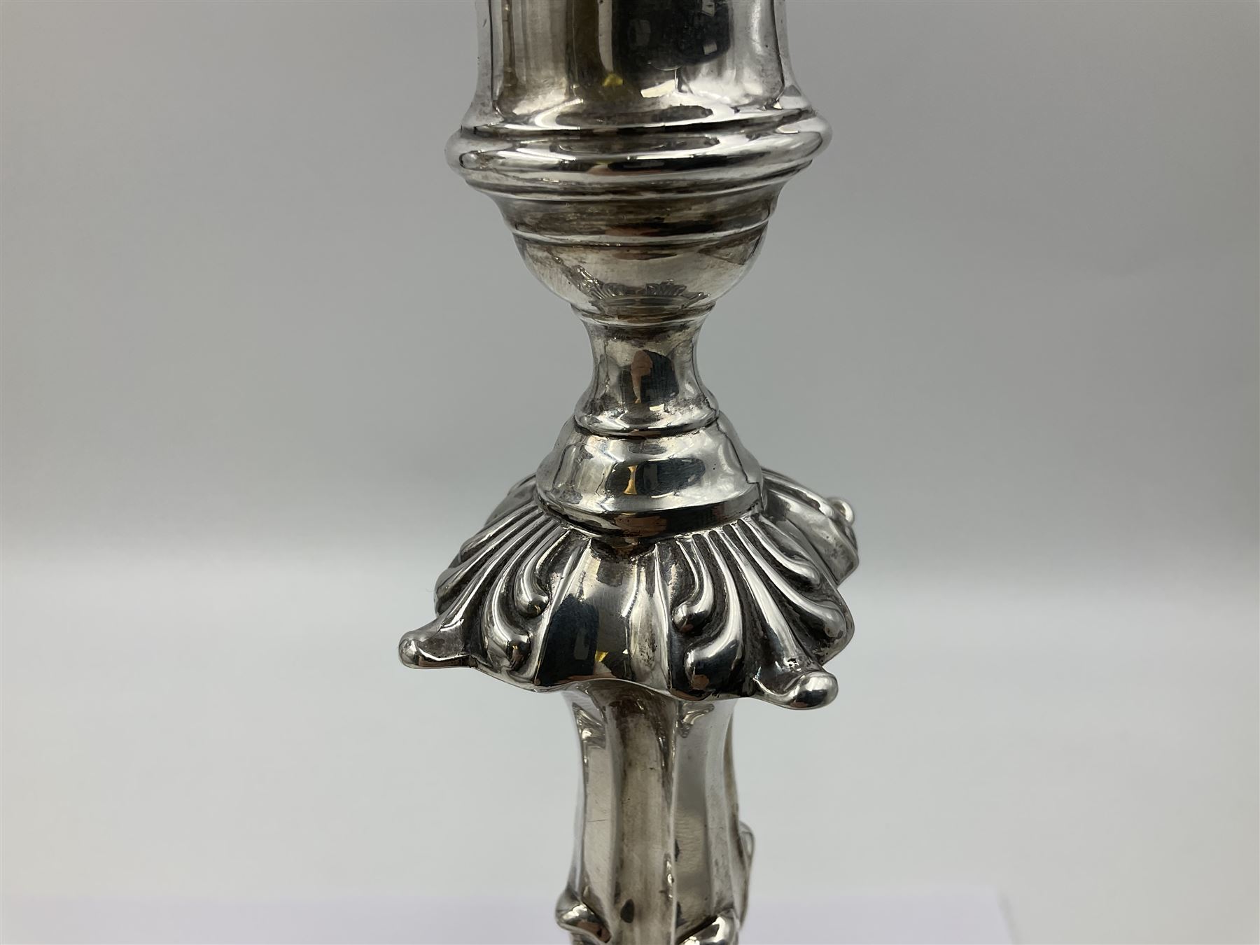Pair of late Victorian silver mounted candlesticks, each of knopped and part fluted form, upon square stepped base with anthemions to each corner, with conforming sconces, hallmarked to removable sconces and foot, Thomas A Scott, Sheffield 1901, H25.2cm