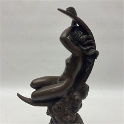 Bronze figure modelled as a nude female figure seated on a crescent moon, upon a stepped circular base, H29cm 