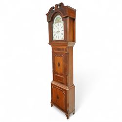Mid 19th century- 8-day oak and mahogany longcase clock, with a carved swan necked pediment and crossbanding, break-arch hood door flanked by reeded pilasters, broad trunk with matching pilasters to the sides, short triple spire door with inlay and a and raised panel beneath, plinth with a conforming inlaid panel to the front, raised on backet feet, painted dial with floral spandrels and a rolling moon to the arch, broad Roman numerals, seconds dial, date aperture and stamped brass hands, dial pinned to a rack striking weight driven movement striking the hours on a bell. With weights and pendulum.