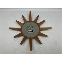 Mid-century teak sunburst wall clock by Anstey & Wilson, modelled with angular teak rays spreading from circular mount with plain brass face with Roman numerals, with battery operated Japanese movement, D45cm