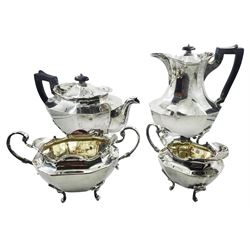 Early 20th century four piece tea service, comprising teapot, hot water pot, twin handled open sucrier and milk jug, each of faceted oval form with scrolling rim, the teapot and hot water pot with ebonised handle and finial, the open sucrier and milk jug with scroll handles, each upon four scroll mounted scroll feet, hallmarked Manoah Rhodes & Sons Ltd, Sheffield 1919, including handle teapot H15.5cm hot water pot H21.5cm, approximate total gross weight 64.32 ozt (2000.8 grams)