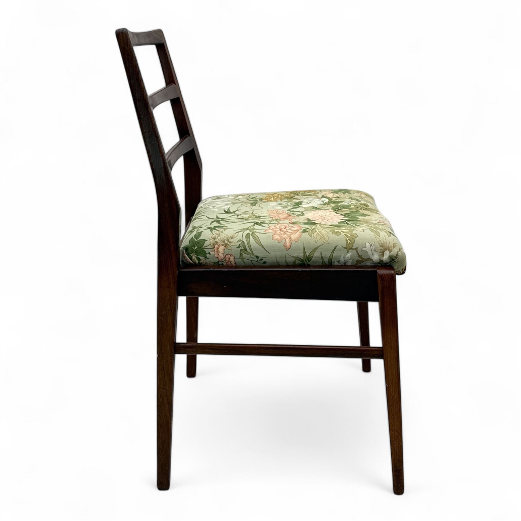 Richard Hornby for Fyne Ladye - mid-20th century afromosia teak dining table, tapered rectangular top with fluted edge and recess for spare leaf, raised on slender legs, teak framed chairs, of ladder back design, with drop-in seat, upholstered seat, with tapered front legs and slightly raked rear legs, retailed by Heals of London, table extended width 181cm depth 86cm height 74cm - chairs width 48cm depth 41cm height 87cm 