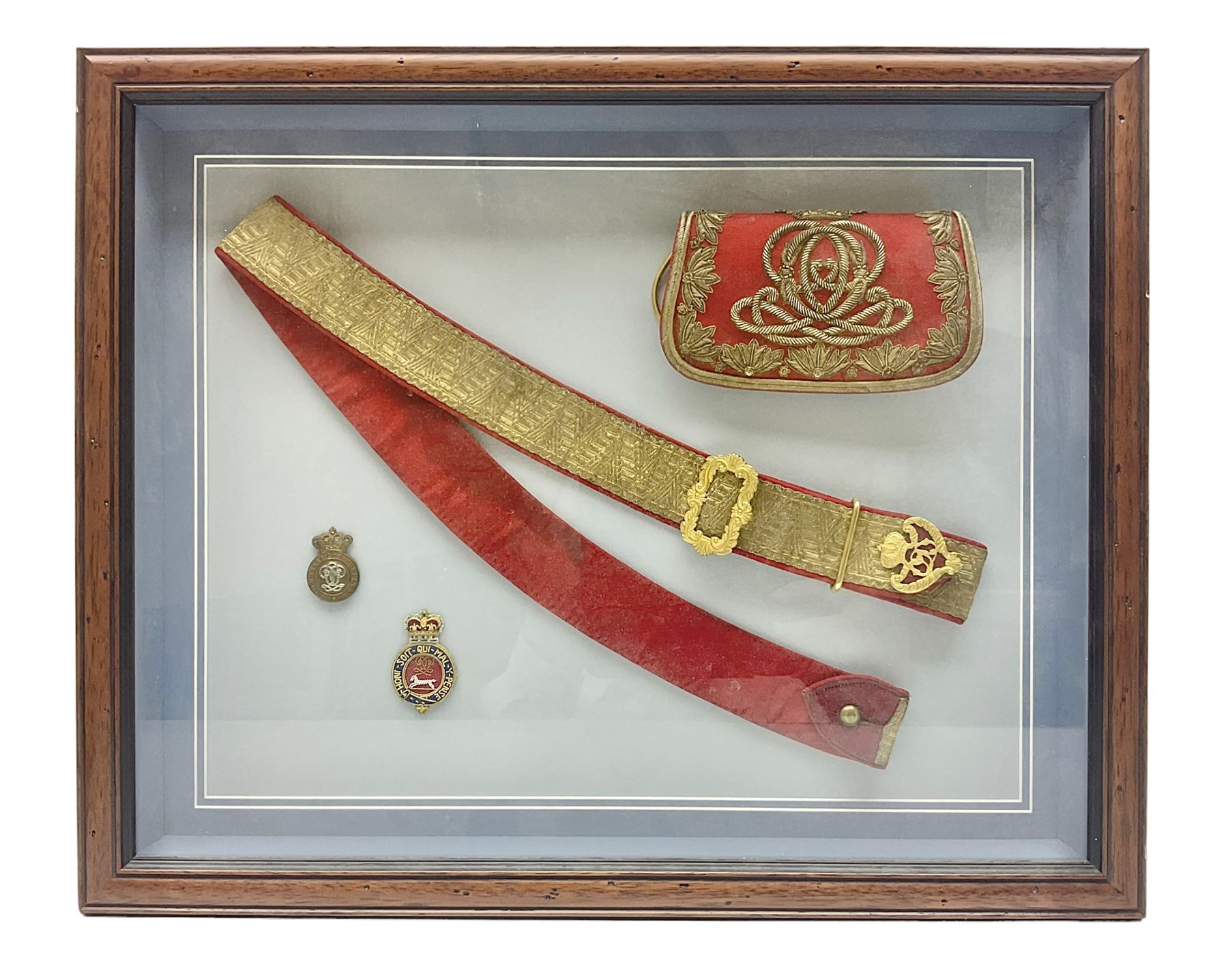 Victorian / Edward VII Queens Own Hussars Officers Full Dress Pouch and Cross Belt; scarlet cloth covered leather pouch with bullion embroidered crown, laurel bordered regimental crest within an edge of embroidered bullion wire; with its original officers cross belt with fine regimental pattern brocade to the top and gilt metal furniture; displayed in a wall hanging case with cloth and metal regimental badges; mahogany stained frame 44 x 54cm