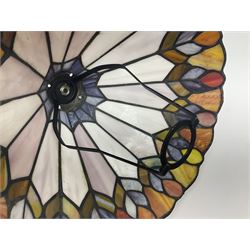 Tiffany style lamp shade, of oval form, with pale peach flowers on a cream and orange lattice ground, together with three other Tiffany style lamp shades and a moulded glass lamp shade with four coloured panels, oval Tiffany style W28.5cm