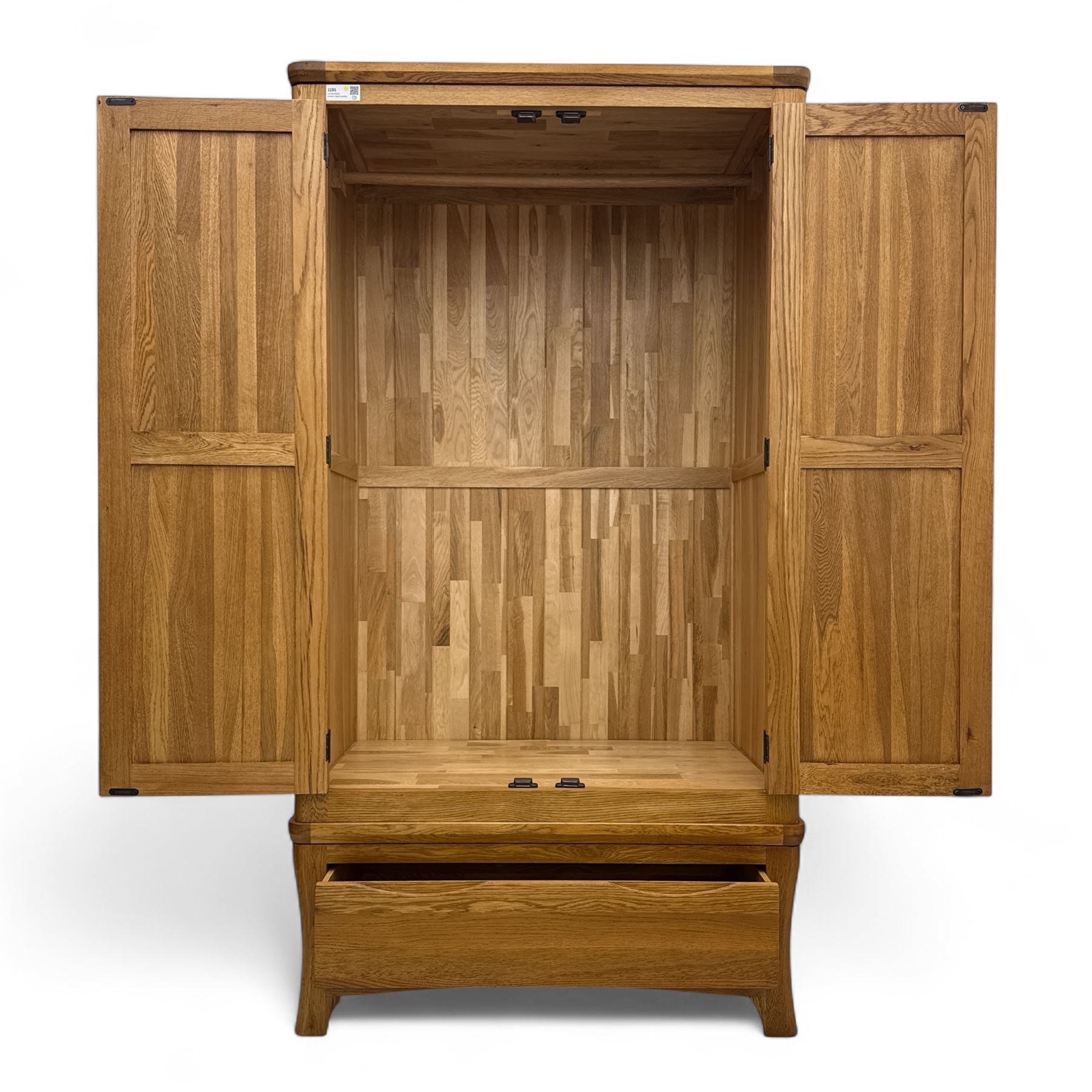 Modern light oak double wardrobe, with twin panelled doors enclosing hanging rail and full-height interior, above a deep lower drawer with recessed handle, shaped stiles