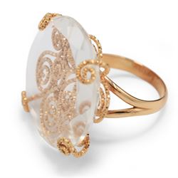 18ct gold rock crystal ring, single round cut crystal, mounted in a fancy textured swirl under setting, stamped 750