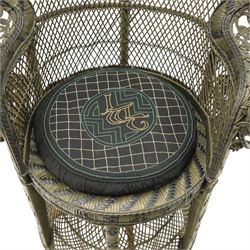 Mid-20th century wicker and rattan Peacock chair in unusual tones of dark olive and black, high fan back with a pieced and woven frame terminating to scrolled arms, with loose seat cushion
