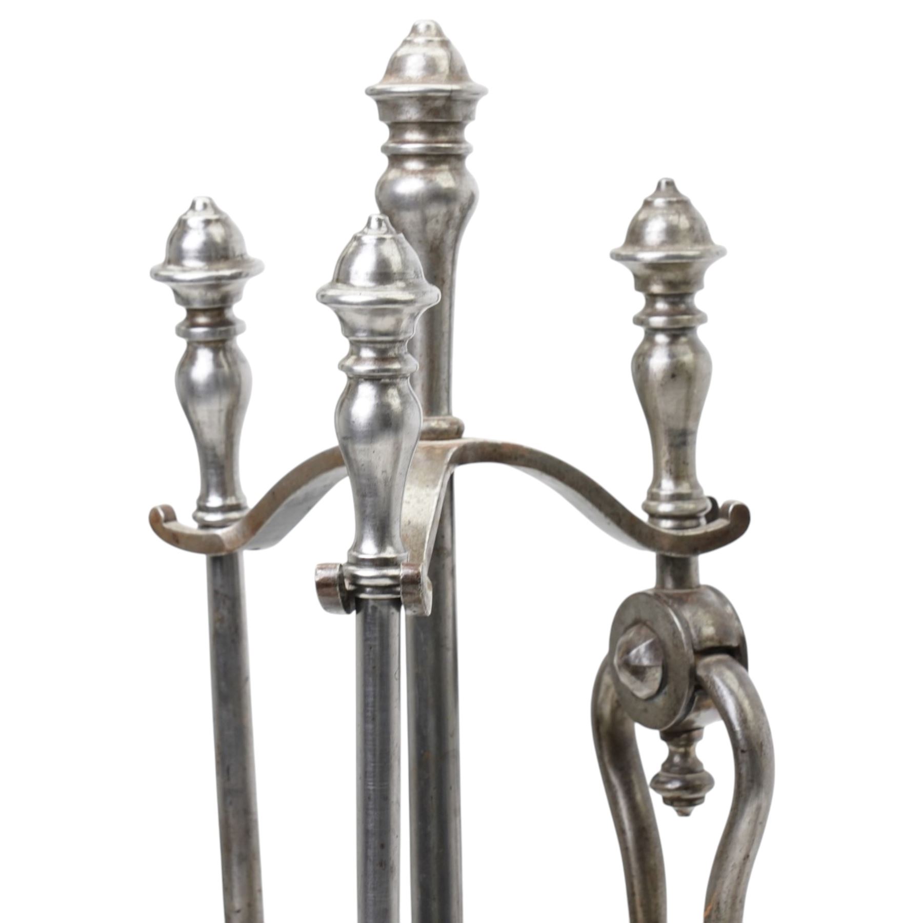 19th century fireside three piece fireside companion, H69cm; together with three further fire irons, and three bellows, one set with crest 
Provenance: Kirkham Hall
