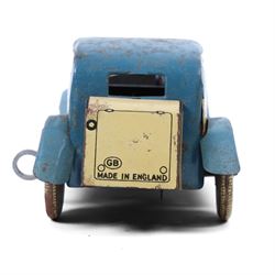Wells tinplate clockwork limousine, the cream body, with blue roof and lithographed details, with driver and key, H8cm, L23cm