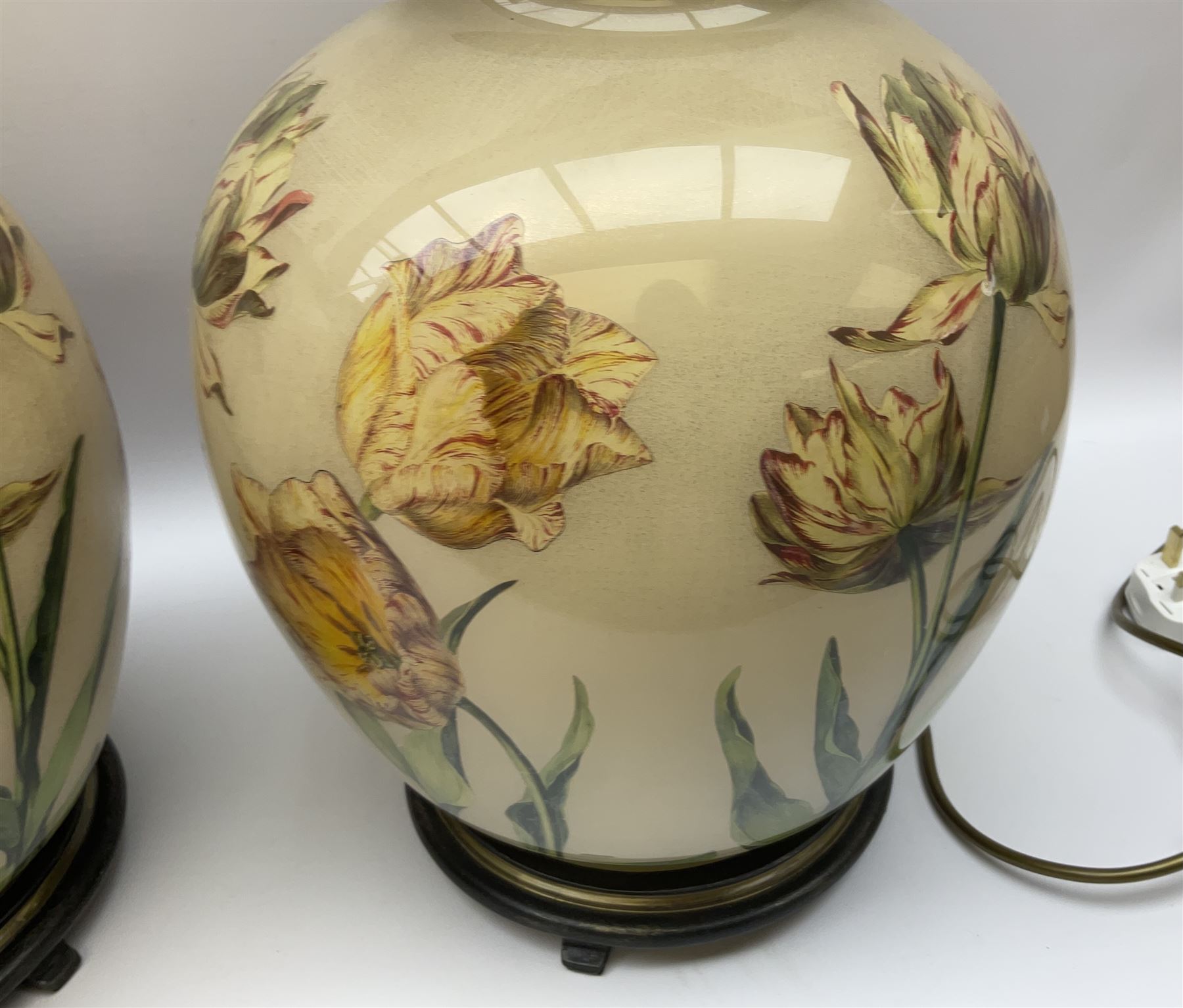 Pair of Potichomania tulip design glass table lamps, by Jenny Worrall, H40cm, with cream pleated lampshades. 