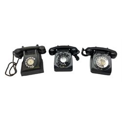 Three black Bakelite telephones with rotary dials, comprising an Ericsson example with base drawer, and two examples marked G.P.O beneath, model no. 706L