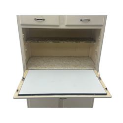 Mid-20th century painted kitchen cabinet, moulded top above a pair of glazed cupboard doors with stylised arrow motif panels, over two drawers and a fall-front cupboard, the lower section with twin cupboard doors