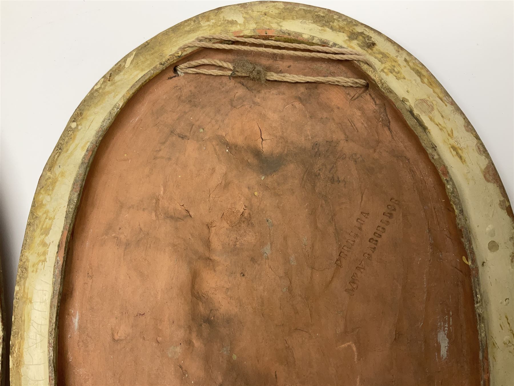 Pair of 19th century classical terracotta relief wall plaques depicting the goddess Hygeia and another goddess, seated holding an ewer, each of oval form, indistinctly signed, each stamped Ferreira verso, H42cm, W30cm