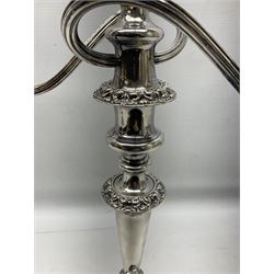 Pair of silver-plated twin branch candelabras, the foliate decorated urn-shaped nozzles raised upon reeded swept branches supported from tapering central stem, with weighted circular stepped bases, H48cm
