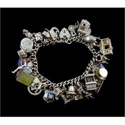 Silver charm bracelet, charms including puppet show, dancers, poodle, camera, ballerina inside a swan, all stamped or tested, approx 2.5oz