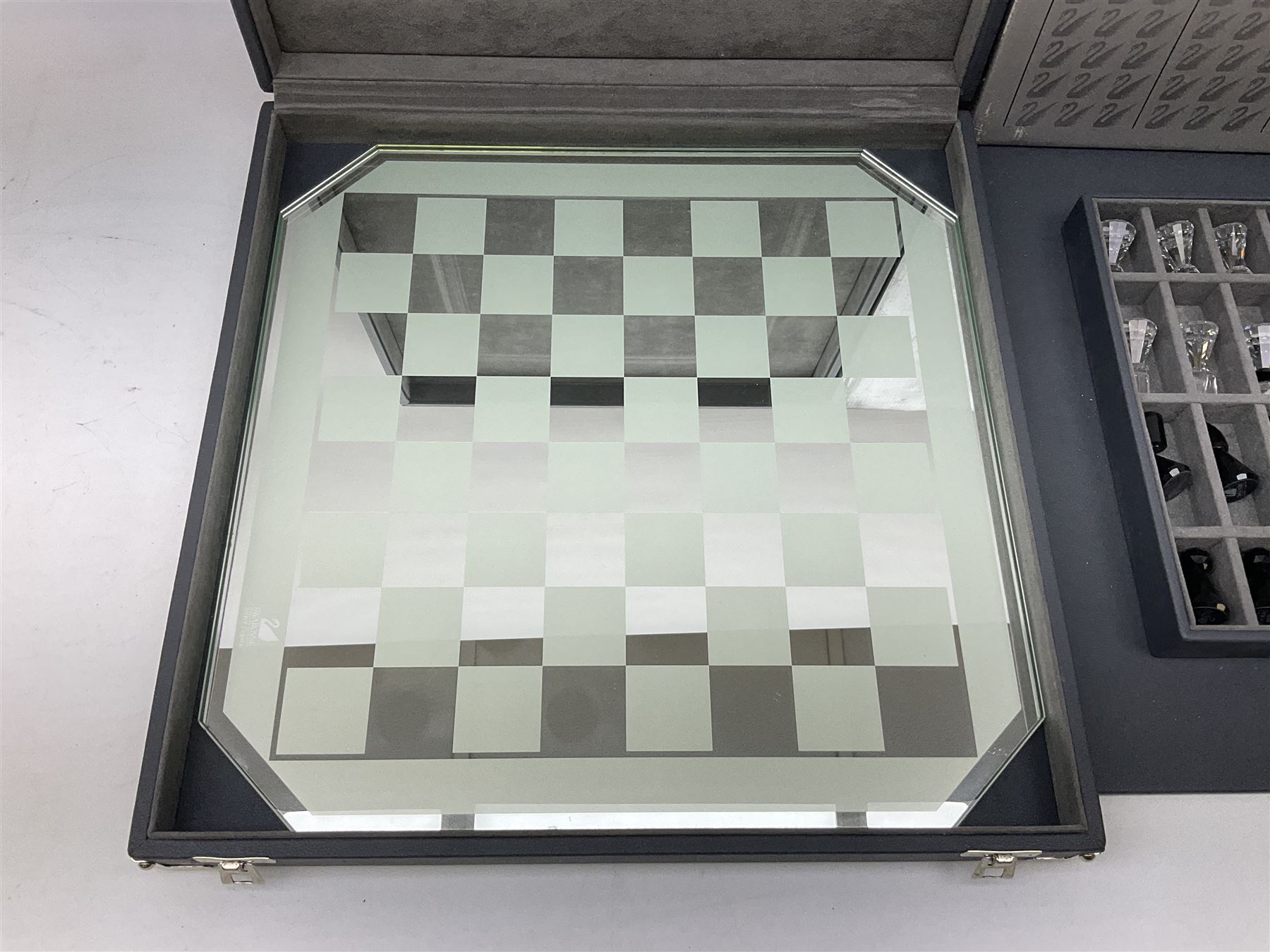 Swarovski silver crystal cut glass chess set, with clear and black pieces on mirrored board, in original presentation box 