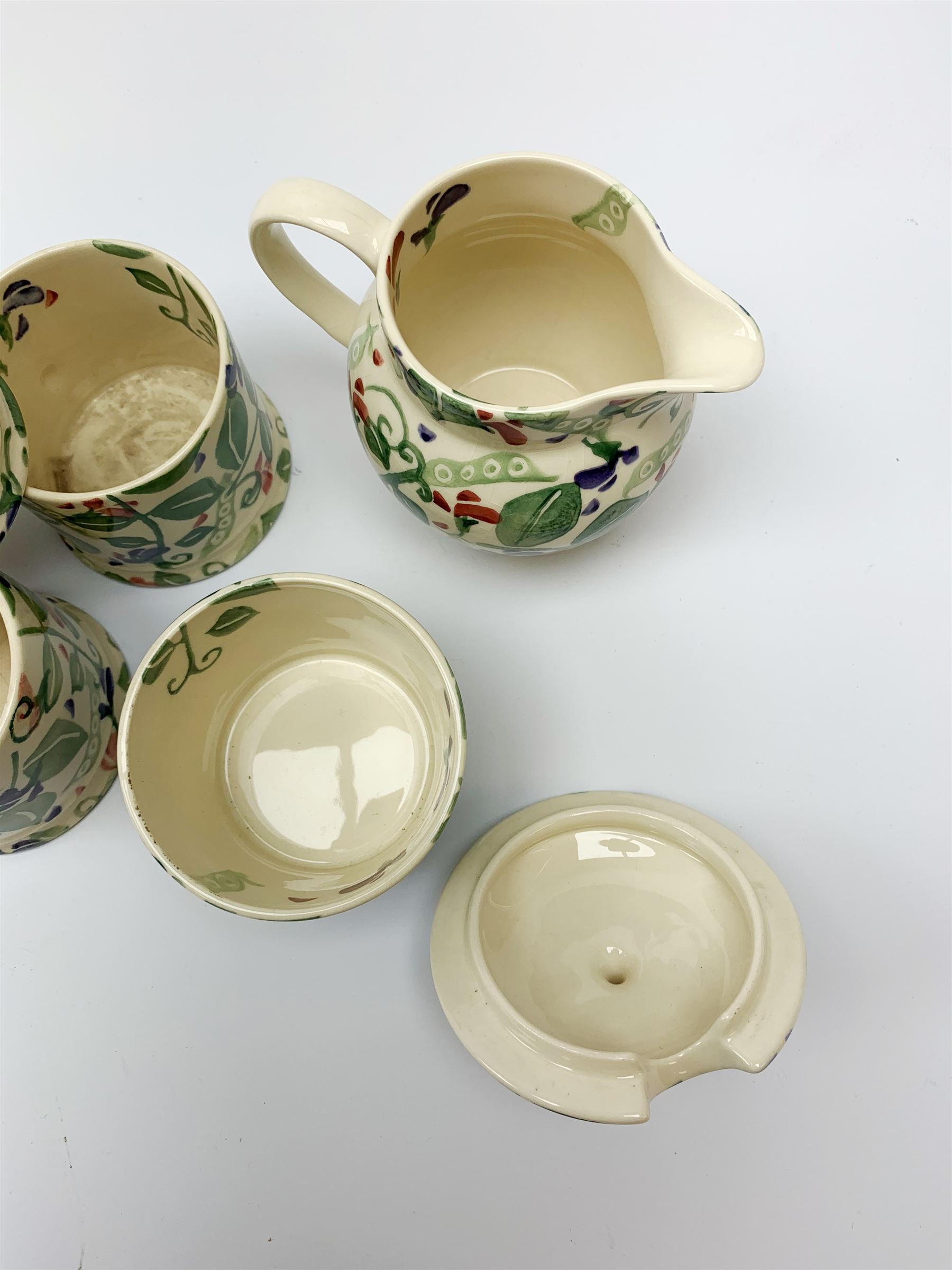 Four Emma Bridgewater mugs, together with a jug, and preserve pot and cover, decorated in sweet pea pattern, mugs H7cm. (5). 