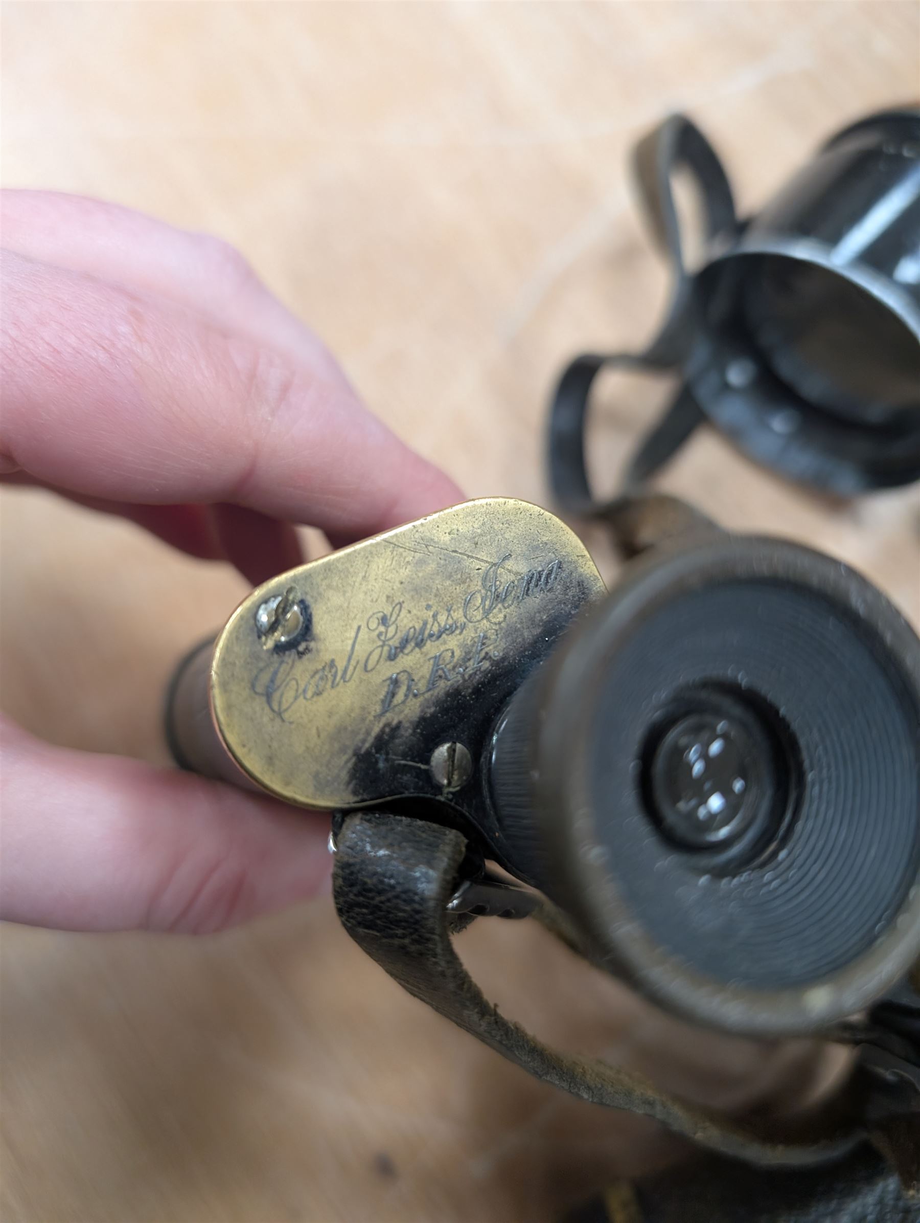 Four pairs of early 20th century binoculars, including Carl Zeiss Jena Feldstecher binoculars, Carl Zeiss Telact 8x binoculars, Dollond x5 field binolculars and one other pair, all in leather cases, one case marked with broad arrow, some with officers name etched