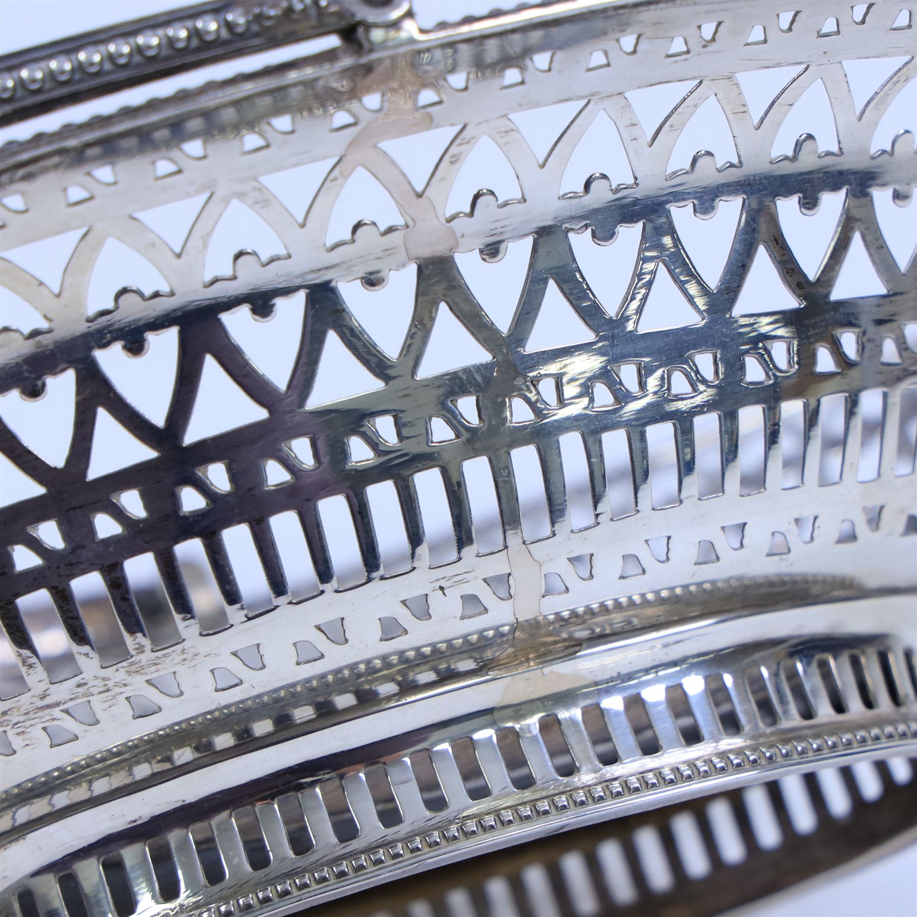 George III silver bon bon basket, of oval form with bead rim and swing handle, the sides with pierced latticework decoration, hallmarked Hester Bateman, London 1785, handle H14cm