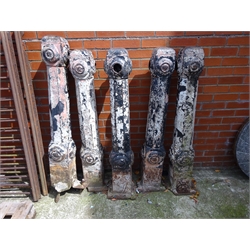  Set of five cast iron bollards, square colums decorated with roundels, H126cm and two sections of cast iron railing, L145cm H79cm (7)  
