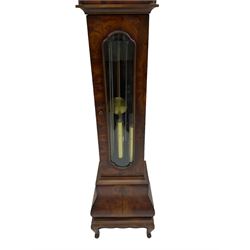 A late 20th century “Grandmother” clock in a figured mahogany veneered case with a break-arch hood and turned central finial,  shaped full length glazed door with visible pendulum and triple brass cased weights, bombe base raised on bracket feet, brass dial with an etched centre, brass spandrels and silvered chapter ring with Roman numerals, working moon dial and pierced steel hands, three train weight driven European movement chiming the quarters on 8 gong rods. With strike /silent feature.

