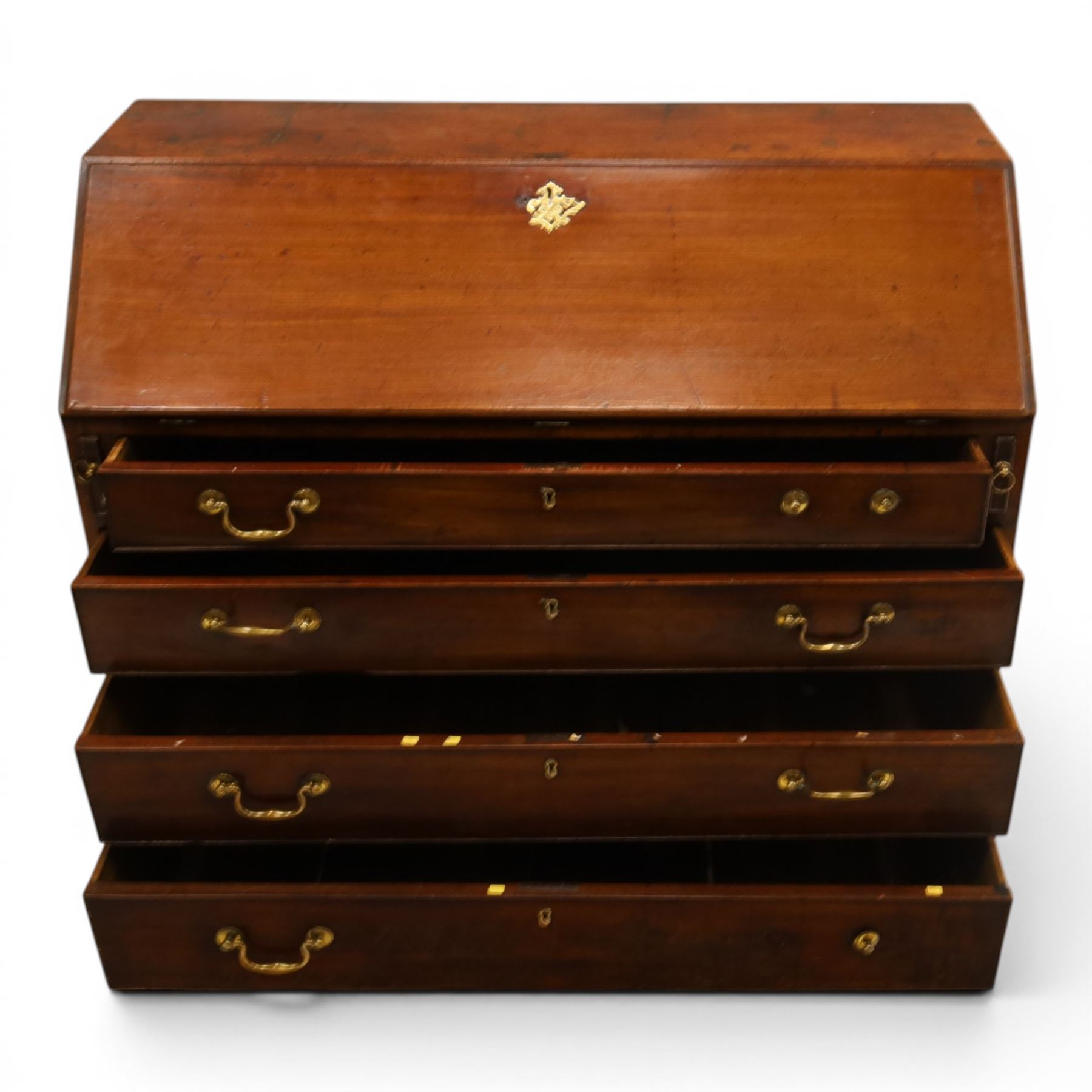 George III mahogany bureau of large proportions, the fall-front enclosing fitted interior with fluted column secret compartments and assorted pigeonholes and correspondence drawers flanking central cupboard, over four graduating cock-beaded drawers with original brass swan-neck handles, raised on bracket feet