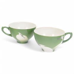 Nishiura Enji (1856-1914), two trio sets comprising tea cup, saucer and plate, with and two extra saucers and plate, decorated with herons upon a green ground and signed to the base, plates D19cm 