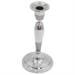 Pair of continental silver candlesticks, probably German Hanau, each of tapering form, with fern leaf decoration, upon a stepped circular base, with Hanau marks and assay scrape to base, H19cm