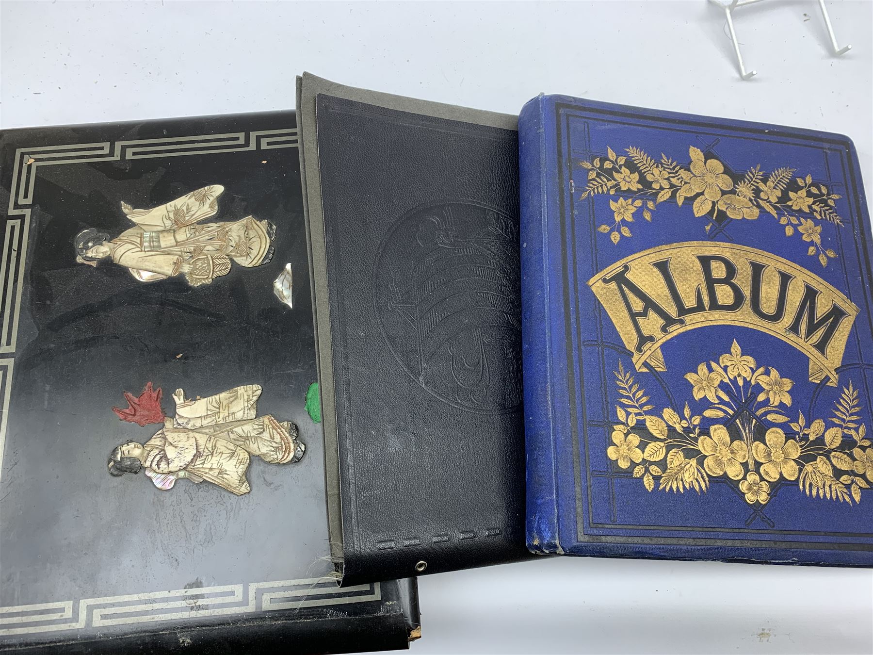 Early 20th century Japanese postcard album, the lacquered wooden covers with shibayama panel to the front, partially stocked with fifty Japanese postcards; Victorian album containing fifty-six laid-in photographs of British & Continental topographical scenes; mid-20th century album of Norwegian photographs; and quantity of Victorian cabinet photographs etc