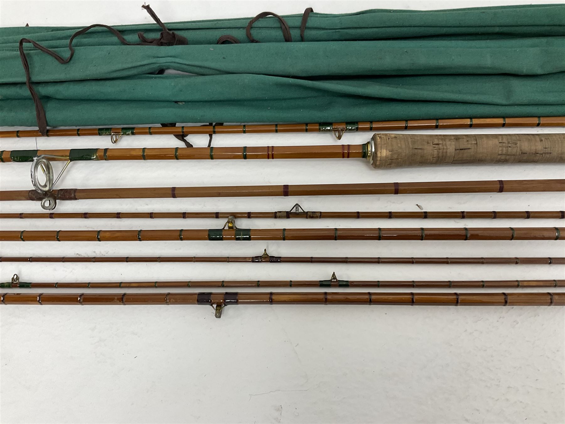 Four split cane fly fishing rods, three made by Burn of Selsdon, the four unmarked, housed in rod bags and a card tube