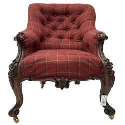 Victorian rosewood framed armchair, upholstered in buttoned tartan fabric, scrolled arm terminals graduating into cabriole supports with moulded flower head decoration and cartouche carved apron, over scroll feet with brass castors
