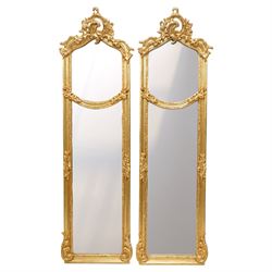 Pair of French Rococo style giltwood pier mirror, of narrow rectangular form, the shaped c...