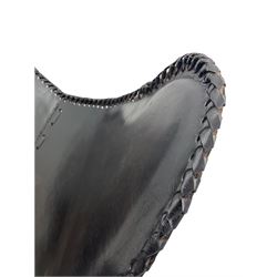 Metal framed butterfly chair upholstered in slung dark tan stitched leather 