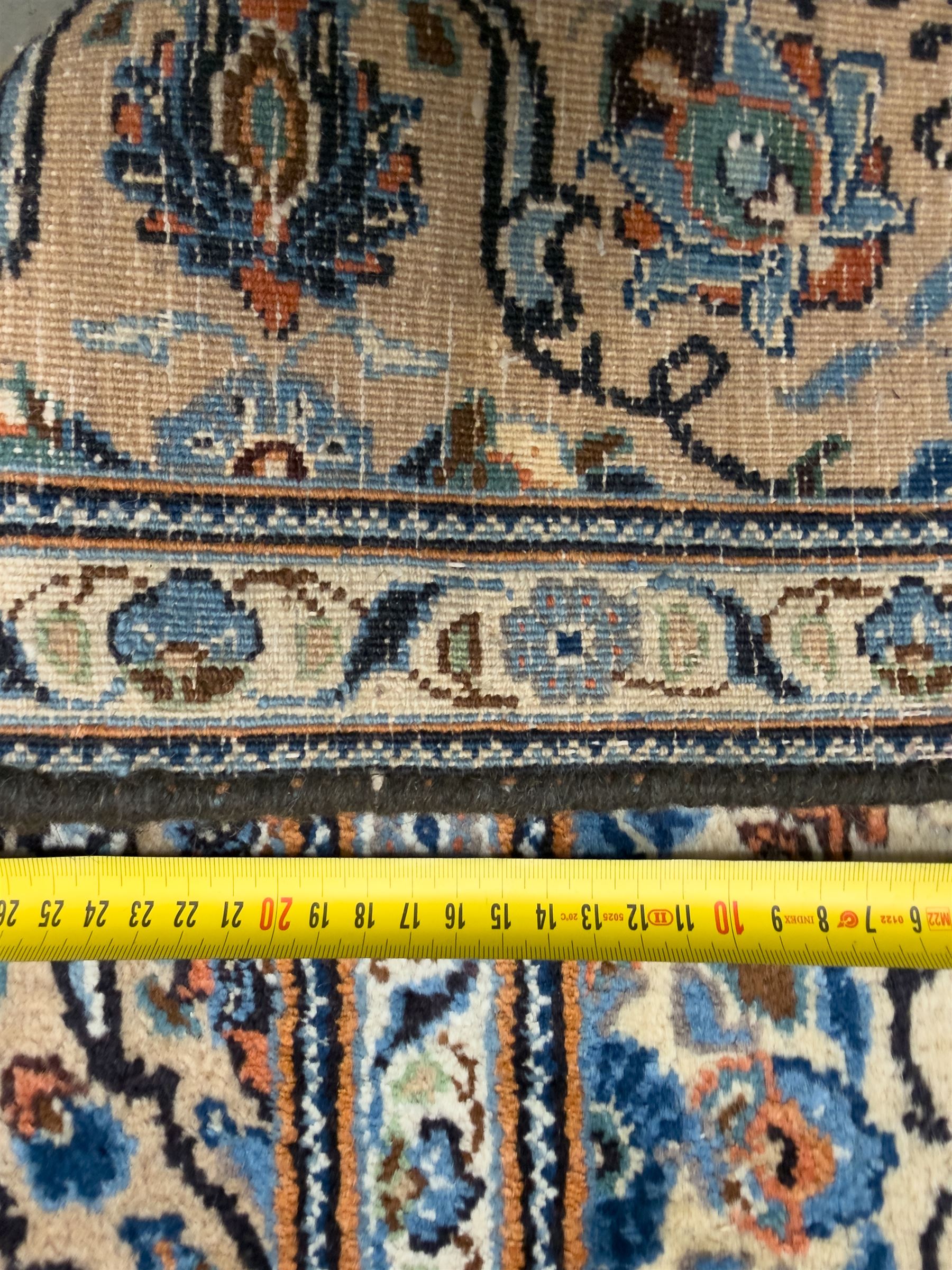 Northwestern Persian Tabriz hand-knotted carpet, the ivory ground with an all-over repeating Herati pattern of stylised palmettes, rosettes and serrated leaves in shades of indigo, terracotta and sky blue, framed by a dark blue border of arabesque vines and scrolling foliage between floral guard stripes, from the region of Tabriz