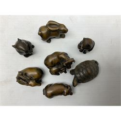 Seven netsuke, modelled as a cat, rat, pig, deer, cow and calf, turtle and rabbit
