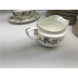 Royal Worcester June Garland pattern tea and dinner wares, comprising thirteen dinner plates, twelve dessert plates, twelve side plates, six twin handled soup bowls and six saucers, six small bowls, sauce boat and stand, thirteen teacups and fifteen saucers, open sucrier, and milk jug