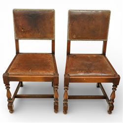 Early 20th century four oak side chairs, with studded leather upholstered backs and seats, on square section legs with baluster turned front supports and straight stretchers