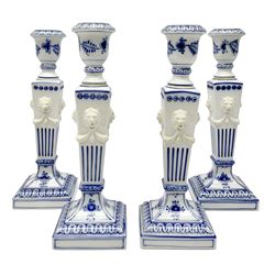 Set of four late 20th century Royal Copenhagen blue fluted candlesticks, of Neoclassical form, the tapering stems with lion masks and husk swag detail, with printed and painted marks beneath, H23cm