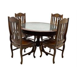 Pakistan carved hardwood brass inlaid circular dining table, and four rail back chairs with saddle seats