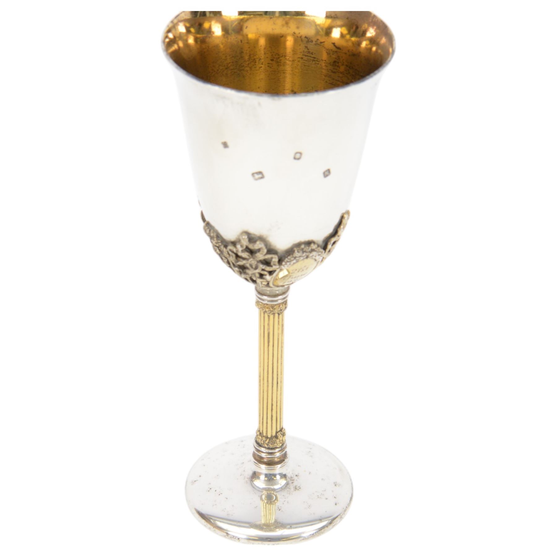 Late 20th century silver goblet, commemorating the birth of HRH Prince William of Wales 21st June 1982, the goblet of plain form, with parcel gilt daffodils and ribbons atop a parcel gilt column stem upon a circular foot, hallmarked St James House Company, London 1982, H19.5cm