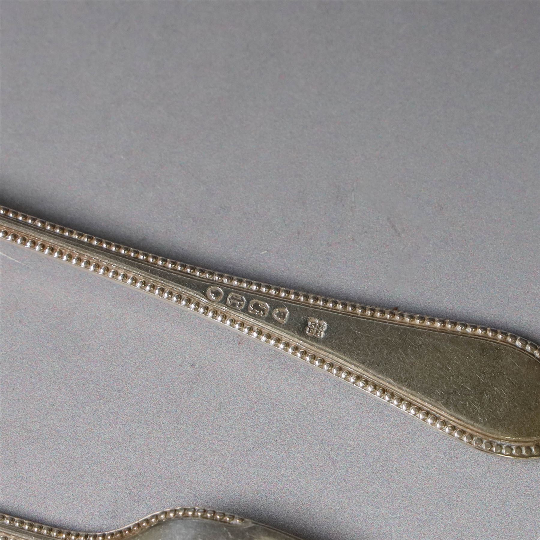 Victorian silver spoon and fork set, each with bead rim and engraved monogram and a silver spoon with scroll handle, with bright cut engraving to underside of bowl, all hallmarked 
