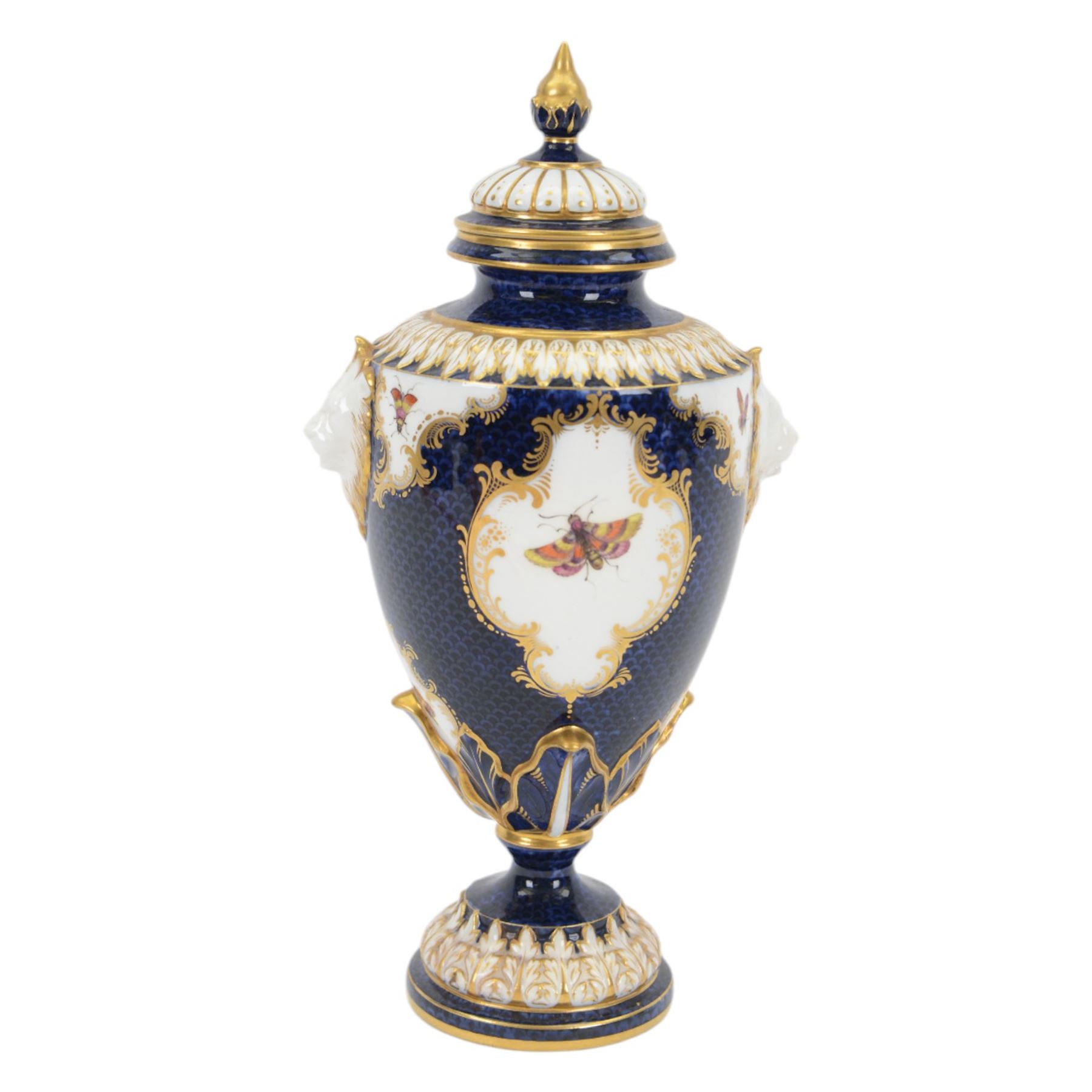 Late 19th century Royal Worcester porcelain vase and cover, circa 1897, of baluster form with twin lion masks to shoulders, painted with a reserve of exotic birds within a landscape, against a blue scale ground with gilt highlights, and further detailed with smaller reserves containing butterflies, the shoulder, base of body and foot with moulded acanthus bands, upon a circular spreading foot, with green printed marks beneath including shape number 2305 and Rd no 419210, H27.5cm