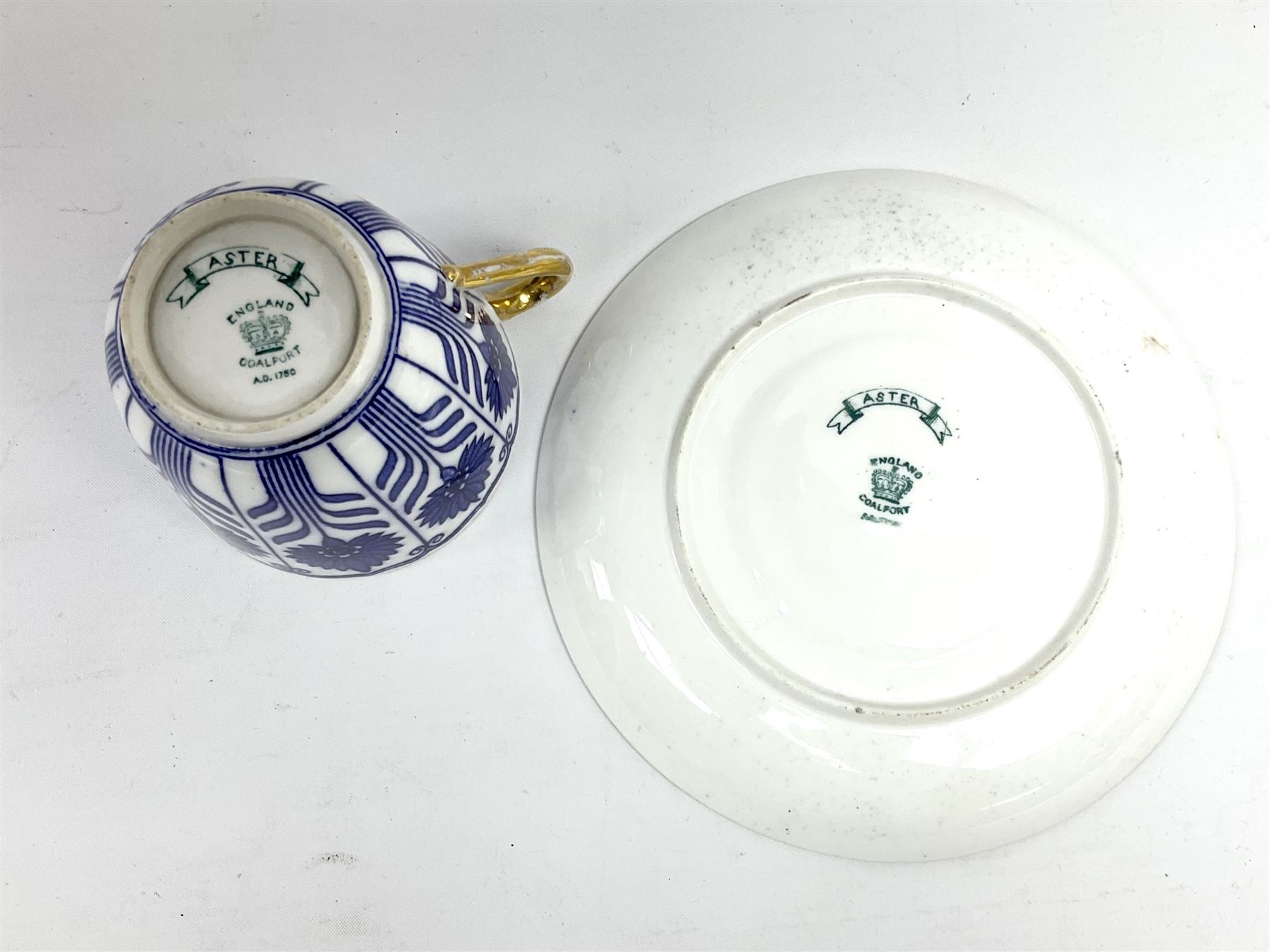 Late 19th century Coalport porcelain cup and saucer in the 'Aster' pattern bearing the crest of Express Dairy Company Limited, College Farm, Finchley and decorated with a steam locomotive